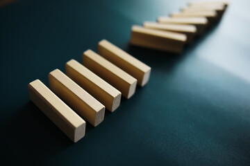 Closeup thick domino wood block in a row stop the falling, be stable in crisis, business solution concept