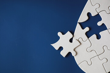 Clean puzzle elements on the background. Empty puzzle piece on the table. Teamwork concept.