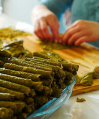 a cook making stuffed leaves, making stuffed leaves at home, stuffed leaves from Turkish cuisine,