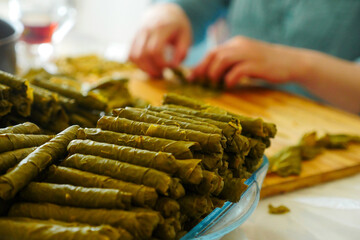 a cook making stuffed leaves, making stuffed leaves at home, stuffed leaves from Turkish cuisine,