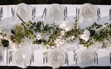 Decor for a wedding ceremony in beige tones, top view. Wildflowers, crystal glasses, crystal...