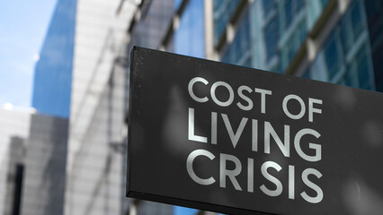 Cost of Living Crisis on a black city-center sign in front of a modern office building	
