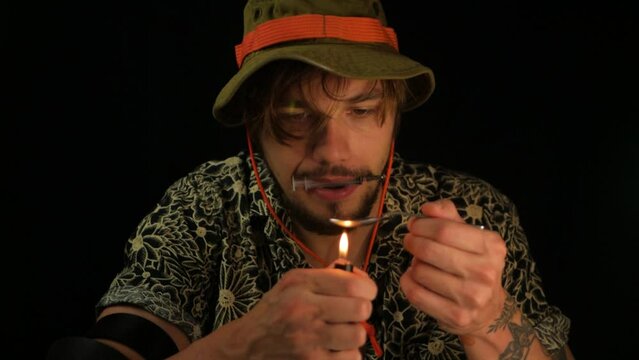 Isolated close up shot of male drug addict heating up liquid in spoon with syringe in mouth. Substance dependent person preparing another dose of poison. Concept of depressed helpless human on drugs
