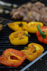 Grilled red and yellow peppers during a street food festival.