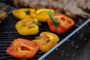 Grilled red and yellow peppers during a street food festival.