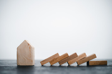 Wooden house model on a pile of wood Idea Refinancing home interest to reduce future expenses Ideas home loan, banking, finance, accounting, insurance
