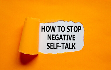 Stop negative self-talk symbol. Concept words How to stop negative self-talk on white paper on a beautiful orange background. Psychological and stop negative self-talk concept. Copy space.