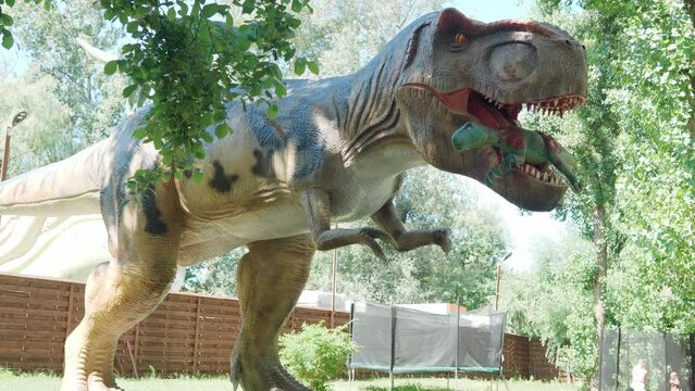 2021.08.12 - Kiev, Ukraine: Motorized Authentic Size Dinosaur Predator Hadrosaurus Mockup in Amusement Forest Park. Exhibition of Moving Models Animals from Jurassic Prehistoric Period in Dinopark