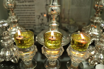 Shabbat candles are lit with oil in silver candlesticks. Orthodox Jewish custom on Saturday night before sunset.
