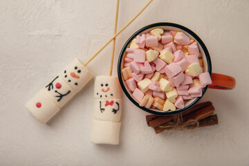 Hot chocolate mug with melted marshmallow snowman.Sweet treat for kids funny marshmallow snowman. Christmas winter holiday decoration. New Year card.Winter hot drink.