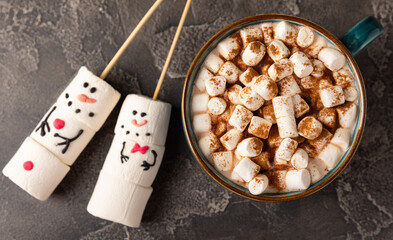 Hot chocolate mug with melted marshmallow snowman.Sweet treat for kids funny marshmallow snowman. Christmas winter holiday decoration. New Year card.Winter hot drink.