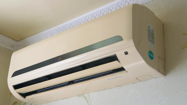 The air conditioner hangs on the wall and cools the air in the room, split system.