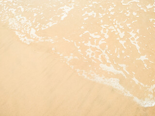 Fototapeta na wymiar Beach and wave of white ocean on sand summer background