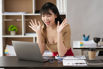 Young business women working and greeting on video conference with happy and smile face on office...