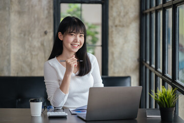 Happy smiling business woman using laptop for working and study at home or office space.