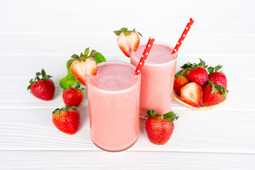 Strawberry yogurt fruit juice smoothie pink colorful fruit juice milkshake blend beverage healthy high protein the taste yummy In glass drink episode morning on white wood background.