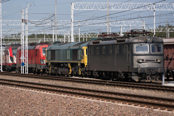 Fototapeta na wymiar LOCOMOTIVES - Electric vehicles on a siding and railway infrastructure