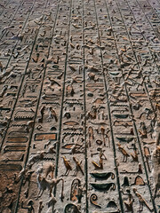 A small stone with hand carved Ancient Egyptian hieroglyphics. This stone is part of a Museum collection of Ancient Egyptian antiquities.