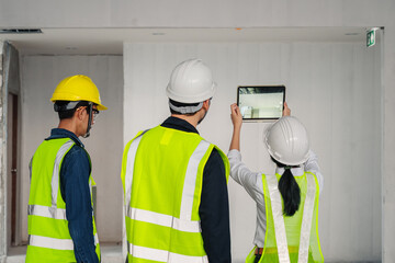 Engineer, architect and construction supervisor Use tablet to record information while inspecting...
