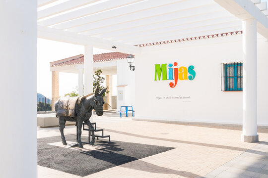 MIJAS PUEBLO, SPAIN - 11 June 2022:  Donkey statue in front of tourist office in Mijas, Andalucia. The town is famous for donkey carriages and white buildings