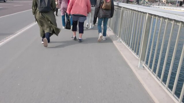 View of people walking on bridge on bright summer day. Europe. Sweden. 