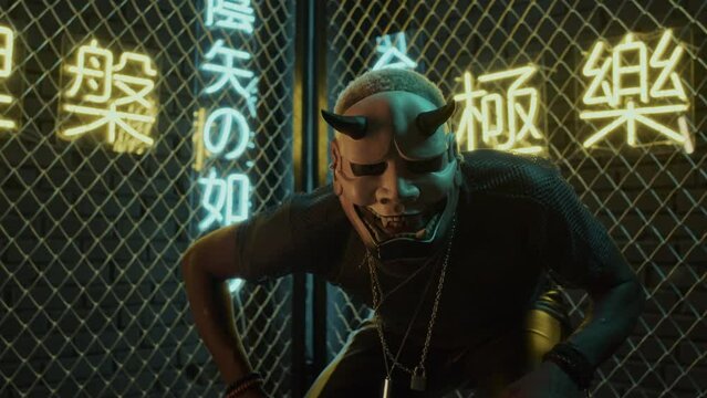 Low angle of young Black man with white hair in mask of demon dancing on camera in studio with netting fence and neon lights meaning nirvana and western paradise