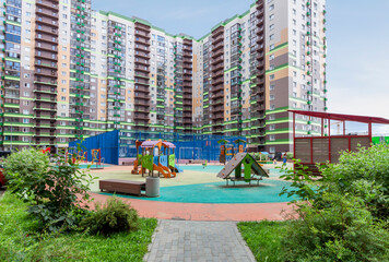 City modern apartment mixed use building with kids playground. Beautiful view housing developments