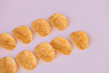 crispy potato chips snack on pink background. Fast food
