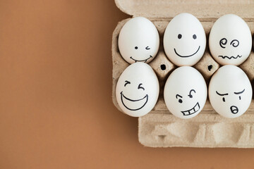 concept social networks communication and emotions - eggs on beige background