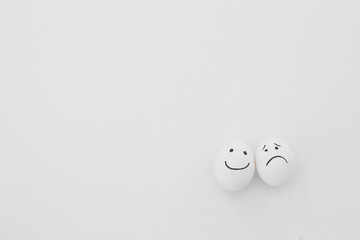 Eggs with funny faces on white background