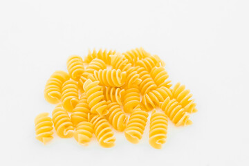 heap of raw macaroni on white background
