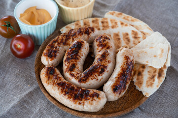 Grilled sausages with sauce and vegetables. Summer rest concept