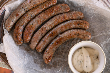 Grilled sausages with sauce and vegetables. Summer rest concept