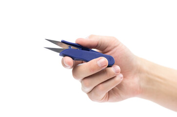 The hand holds scissors for cutting threads. Close up. Isolated on a white background