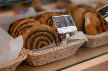 A variety of baked goods are on display. Showcase in the bakery. Various buns and pies