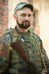 Portrait of a Ukrainian military man with a Kalashnikov assault rifle
