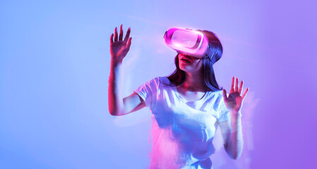 Excited woman wearing vr glasses, raising hands up