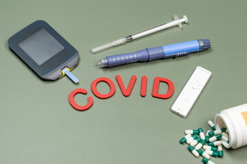 device to measure blood glucose and the word Covid written