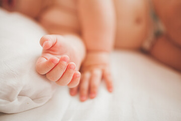 Fototapeta na wymiar Cute little baby sleeping. Tiny infant`s hands in front.