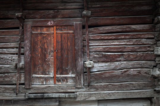Texture of an old wooden door of a barn in the Swiss Alps