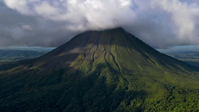 Beautiful cinematic  aerial footage of Arenal Volcano, the arenal Lagoon, and rain forest in Costa Rica