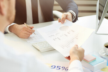 Close-up of unrecognizable employee of business company passing financial paper to boss in office