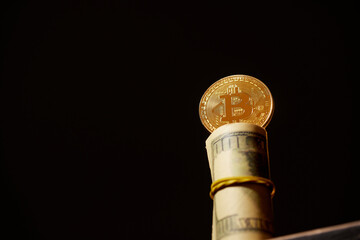 golden bitcoin stands on twisted dollars on dark background, crypto exchange concept