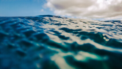 A low angle view of the Pacific ocean blue water in Maui Hawaii for a travel or swimming background with copy space © Ursula Page