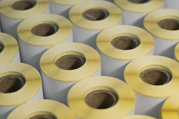 Rollers with a white self-adhesive label for printing labeling information. Ribbon with white label...