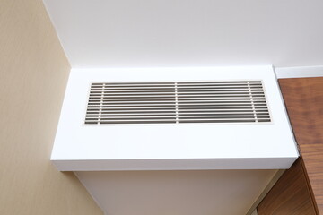 Air conditioning indoor climate system in the wall inside room. Old wall-mounted air grill. Air...