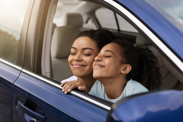 Happy African American Mom And Daughter Sitting In Car