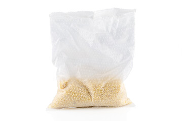 Fototapeta na wymiar Transparent plastic bag with millet porridge on a white background. Close-up.