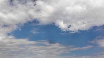Fluffy white clouds and blue sky