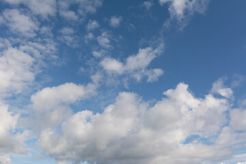 Naklejka premium Fluffy white clouds and blue sky